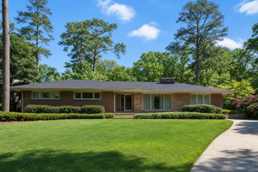 A handsome mid-century modern brick ranch house in Collier Heights at golden hour.